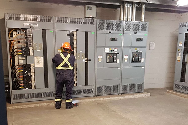 Level III certified thermographer inspecting industrial switchgear during Tampa Bay infrared survey