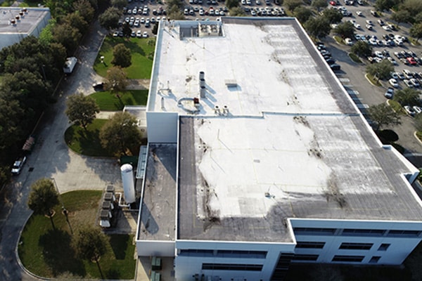 Aerial drone thermography of commercial building rooftop in Tampa Bay — infrared roof moisture survey